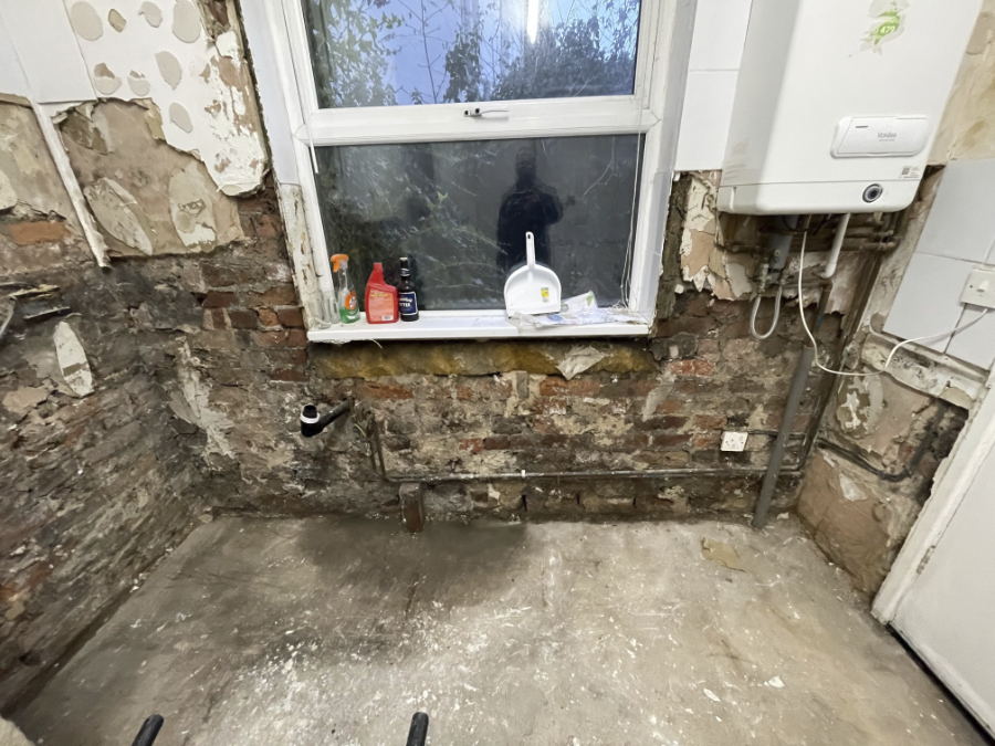 A kitchen has been taken 'back to brick', exposing plumbing and electrics to be updated before replastering and refurbishing